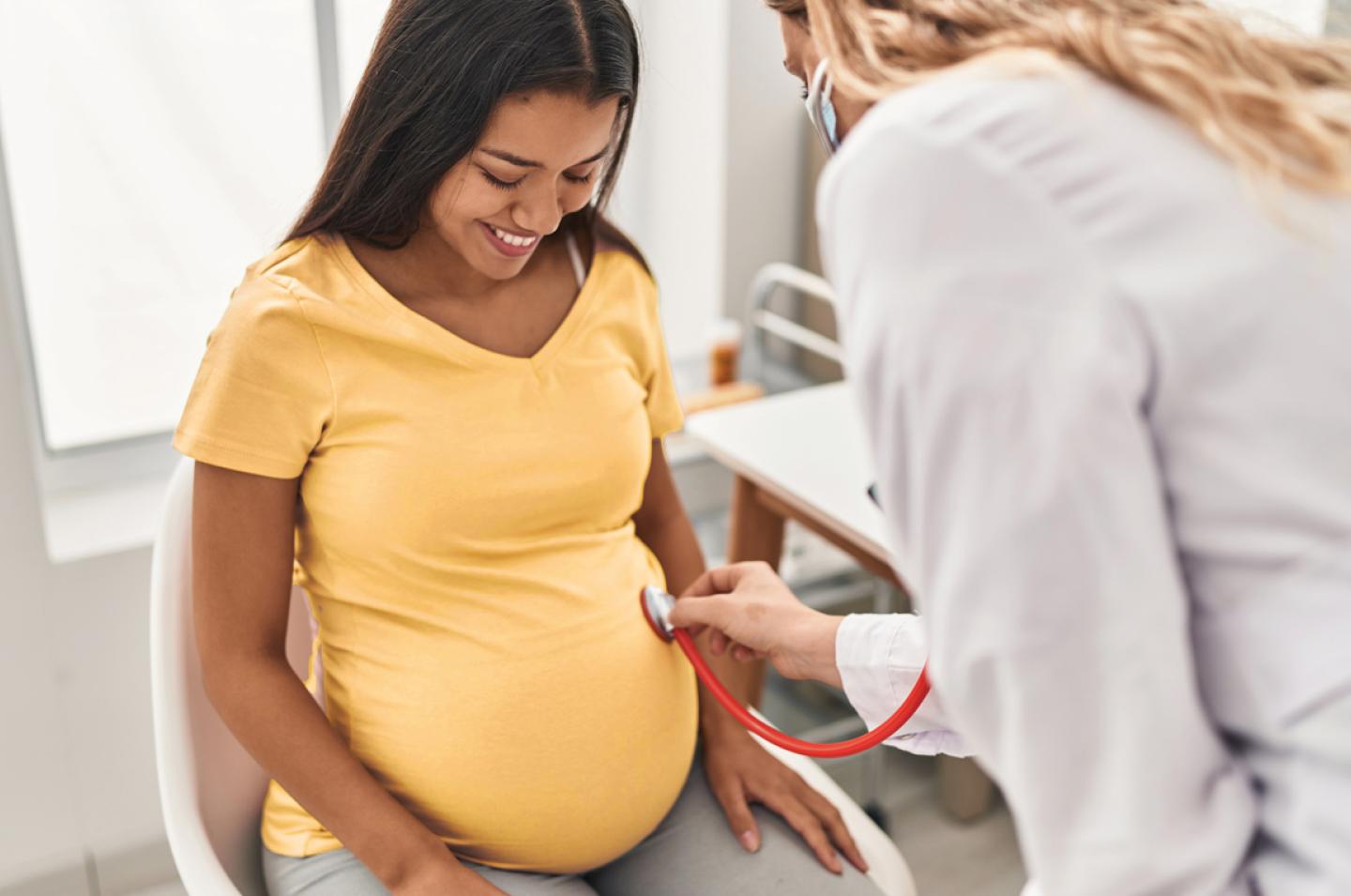 Pregnant woman being examined by doctor